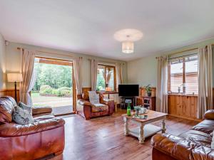 a living room with leather furniture and a tv at 3 Bed in Ledbury oc-77378 in Wilton