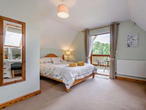 a bedroom with a bed with a mirror and a balcony at 3 Bed in Ledbury oc-77378 in Wilton