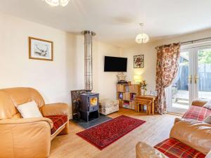 a living room with a wood stove at 2 Bed in Inverness oc-44481 in Drumnadrochit