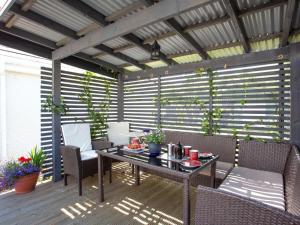 a patio with a table and chairs on a deck at 2 Bed in Inverness oc-44481 in Drumnadrochit