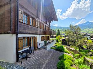a building with a bench on a walkway outside at MOM - Alpine Boutique Apartments, Chalet Fagus, Terrace Studio in Grindelwald