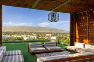 a balcony with chairs and a view of a city at Aura Villas Skopje in Skopje