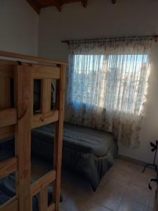 a bedroom with two bunk beds and a window at El Galpon Aparts in General Pacheco