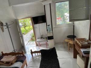 a room with a bed and a kitchen with a window at Rooms Struga free parking quiet area in Struga