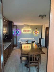 a kitchen with a table and a bed in a room at Illumina House 3 in Giurdignano
