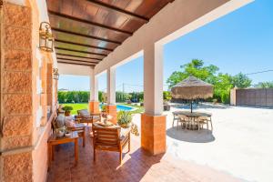 an outdoor patio with a table and chairs at Casa Rural Villa Lucrecia in La Lantejuela