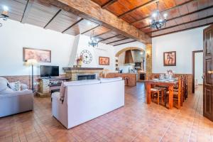 a living room with a couch and a table at Casa Rural Villa Lucrecia in La Lantejuela