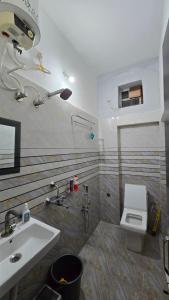 a bathroom with a sink and a toilet at Deoghar BnB in Deoghar +21 photos