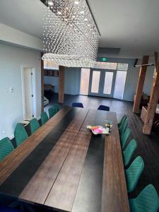 a large wooden table with green chairs in a room at Myers Cave Resort in Cloyne +85 photos