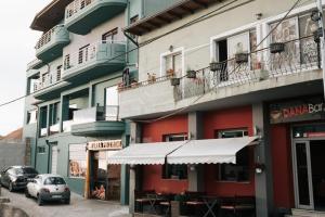 a building with cars parked in front of it at SD Guest Villa in Krujë