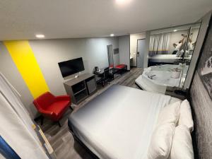 a hotel room with a bed and a bathroom at Super 8 by Wyndham Macomb in Macomb