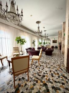 a living room with a lobby with a chandelier at Hotel Cristallo - Chianciano Terme in Chianciano Terme