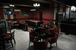 a restaurant with a pool table in a room with chairs at SD Guest Villa in Krujë
