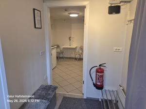 a fire extinguisher hanging on the wall of a hallway at Basement hideaway in Akureyri +11 photos