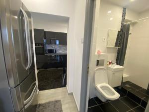 a small bathroom with a toilet and a sink at Apartament Kiri in Mangalia