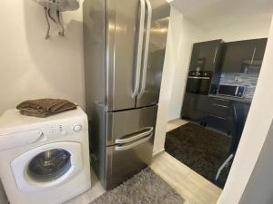 a kitchen with a refrigerator and a washing machine at Apartament Kiri in Mangalia +17 photos