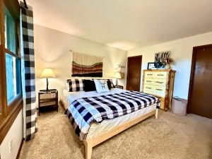 a bedroom with a bed and a dresser at Paws at the Peak in Beech Mountain