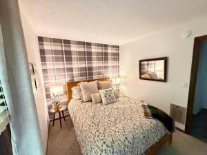 a bedroom with a bed with two pillows on it at Paws at the Peak in Beech Mountain +32 photos