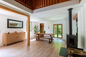 a living room with a wood stove and a bench at Chalet du Lacus in Boutx