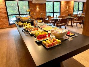 a buffet of food on a table in a restaurant at Oasis Plaza Hotel in Ribeirão Preto