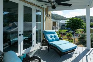 a screened porch with a chair and a fan at Mahalo Villa Beachfront Generator in Cruz Bay +16 photos