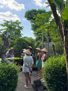 a group of people wearing hats standing around at Daphne Homestay & Cooking Class in Senggigi