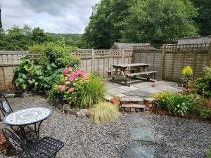 a garden with a picnic table and a bench at 3 Bed in Ulverston oc-sz549 in Backbarrow