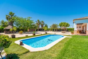 a swimming pool in the yard of a house at Casa Rural Villa Lucrecia in La Lantejuela