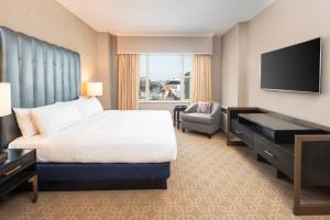 a hotel room with a bed and a television at The Marc Hotel in Milwaukee
