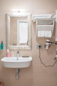 a bathroom with a sink and a mirror at B&B di MARE in Orta Nova