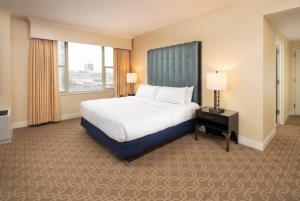 a hotel room with a bed and a large window at The Marc Hotel in Milwaukee
