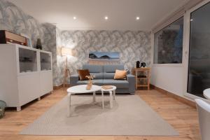 a living room with a couch and a table at La Concha Pearl Beach Apartment in San Sebastián