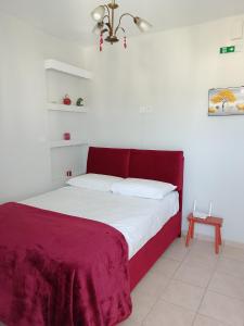 a bed with a red headboard in a bedroom at Heavenly joy in Patra
