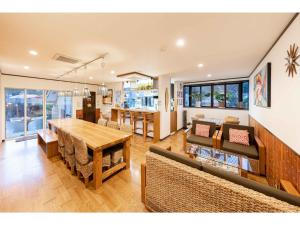 a dining room and living room with a table and chairs at THINK - Vacation STAY 30630v in Ichigaya