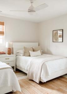 a white bedroom with a white bed and a white dresser at Airy 3BD Cottage Yard Grill & Steps to Beach in Folly Beach