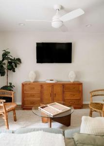 a living room with a flat screen tv on a wall at Airy 3BD Cottage Yard Grill & Steps to Beach in Folly Beach +32 photos