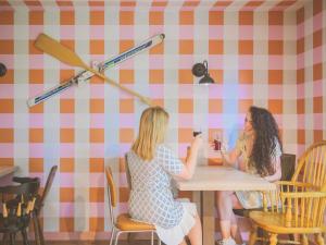two women sitting at a table in a restaurant at greet hôtel Annecy Cran-Gevrier by Accor in Annecy