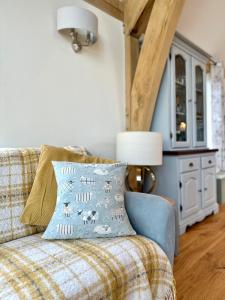 a couch with a pillow on it in a living room at Holly Barn in Worcester