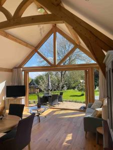 an open living room with a large glass window at Holly Barn in Worcester