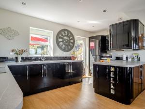 a kitchen with a large clock on the wall at 3 Bed in Shanklin oc-ic180 in Shanklin
