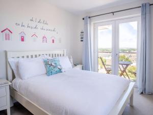 a bedroom with a white bed and a window at 3 Bed in Shanklin oc-ic180 in Shanklin