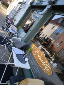 a group of chairs sitting outside of a store at Pension am Dom in Erfurt