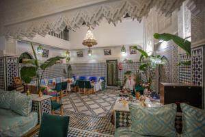 a lobby with a table and chairs in a room at Riad YAMNA - Quiet Desire in Fez