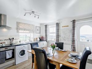 a kitchen with a wooden table and a dining room at 2 Bed in Harrogate oc-hh018 in Lindley