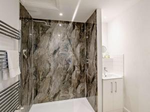 a bathroom with a shower with a marble wall at 2 Bed in Harrogate oc-hh018 in Lindley +15 photos