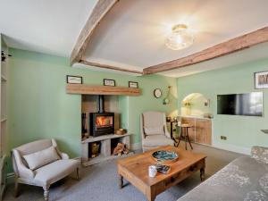 a living room with a fireplace and a table at 3 Bed in Settle oc-92466 in Settle