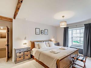 a bedroom with a large bed and a window at 3 Bed in Settle oc-92466 in Settle