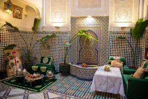 a living room with a couch and a table at Riad YAMNA - Quiet Desire in Fez