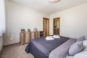 a bedroom with a bed with two pillows on it at Apartmán Zara in Telgárt