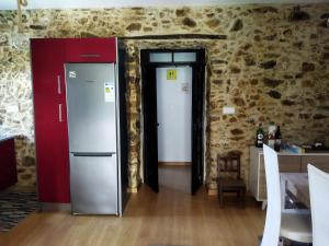 a kitchen with two doors and a refrigerator at Quinta da Preciosa in Nebrijo +9 photos